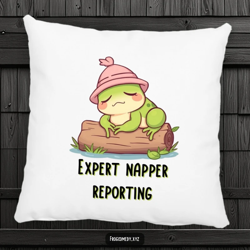 Funny pillow design of a sleepy frog wearing a miniature hat, dozing soundly on a log.