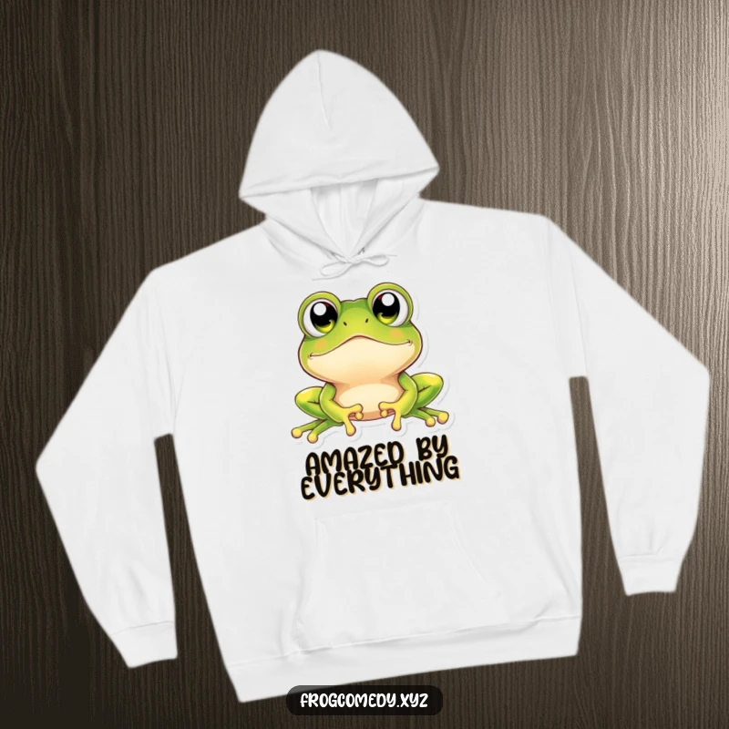 Funny kawaii frog hoodie with a cute amphibian character possessing oversized, sparkling eyes, looking upwards with a sense of delightful surprise.