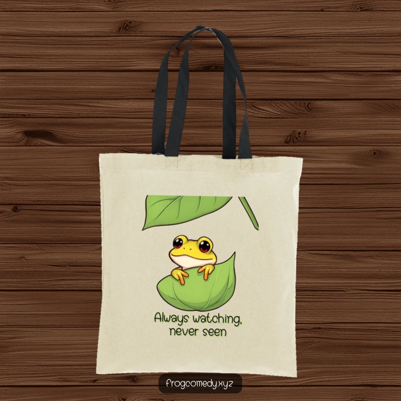 Funny curious frog tote bag, showing an amphibian peeking from behind a leaf, ideal for carrying items with a humorous and nature-inspired flair.